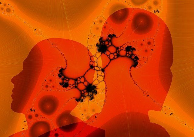 Image de deux silhouettes humaines couleur orange reliées par un réseau neuronal. 